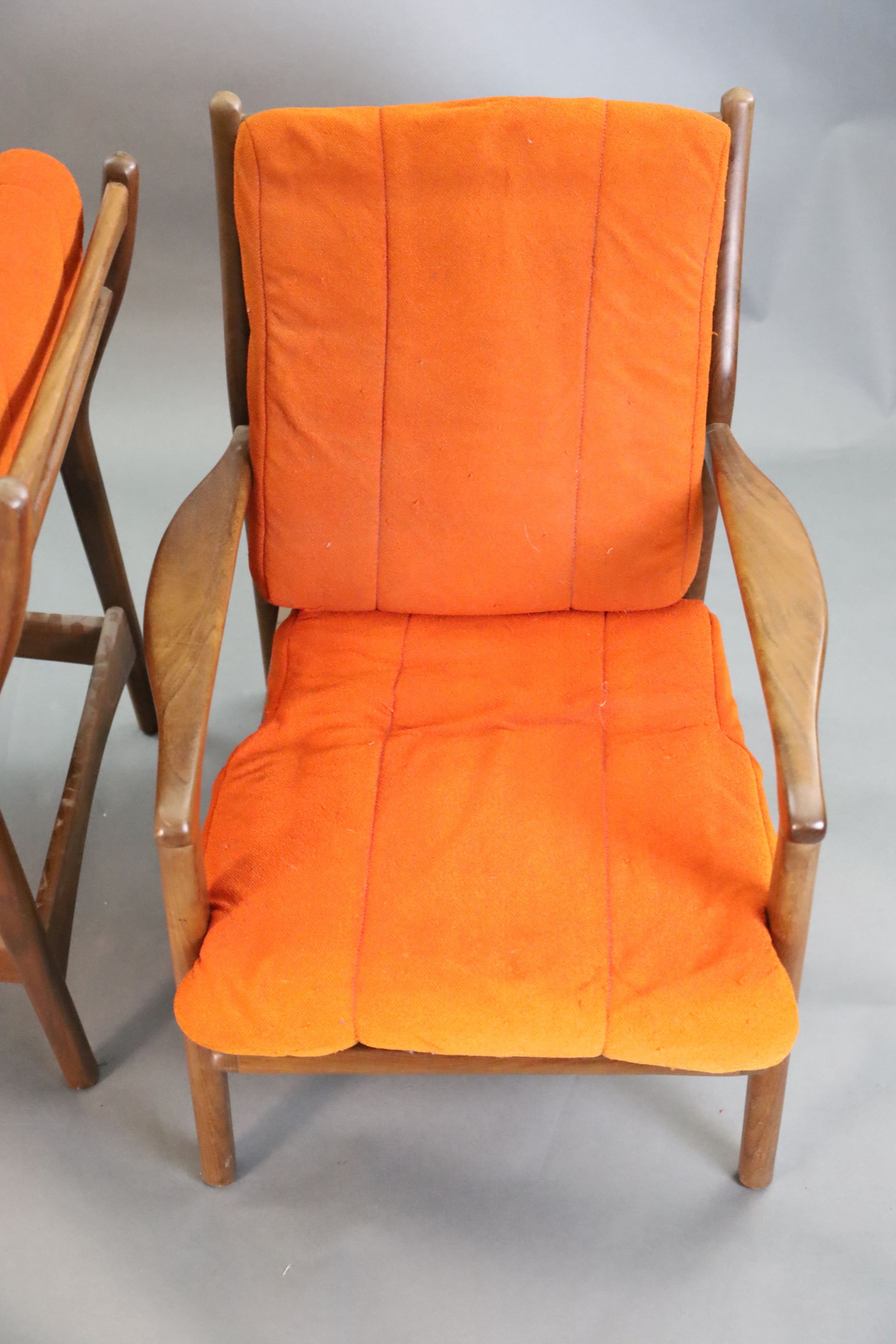 A pair of mid century Danish teak armchairs, W.2ft 2.5in. D.2ft 10in. H.2ft 8in.